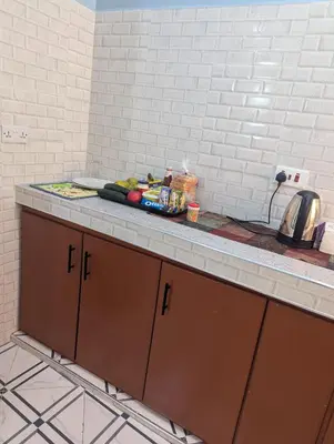a kitchen counter with a plate of food on it at Utulivu Home Stay Apartment in Arusha