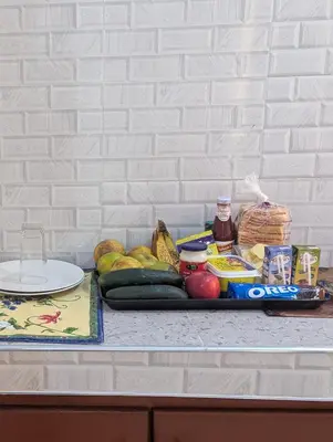 a tray of fruits and vegetables on a counter at Utulivu Home Stay Apartment in Arusha