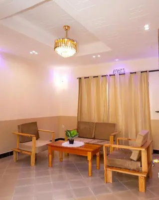 a living room with a couch and a table at Richard's Road Homestay in Boma la Ngombe