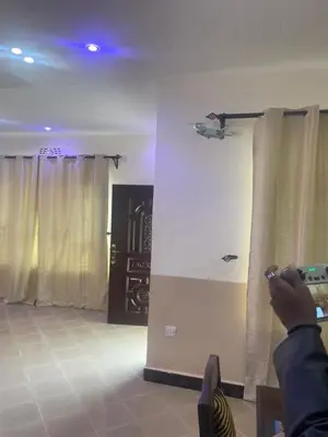 a person taking a picture of a room with curtains at Richard's Road Homestay in Boma la Ngombe