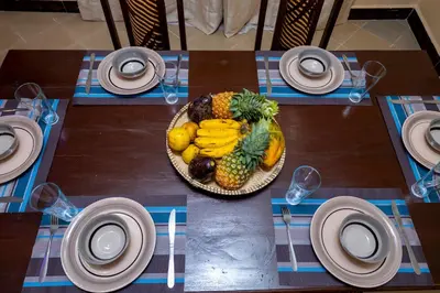 a plate of fruit and vegetables on a table at Richard's Road Homestay in Boma la Ngombe