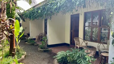 a house with a porch with chairs and plants at Kwetu Villa in Arusha
