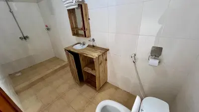 a bathroom with a sink and a toilet at Kwetu Villa in Arusha