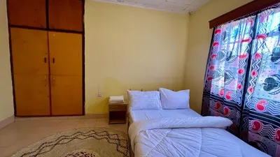 a bedroom with two beds and a window at Kwetu Villa in Arusha