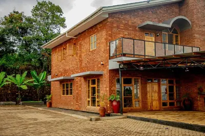 a brick building with a balcony on top of it at Tranquil Hillhouse in Nkoanrua