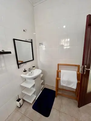a white bathroom with a sink and a mirror at 1 Bedroom- Tranquil Meru Retreat in Nkoanrua