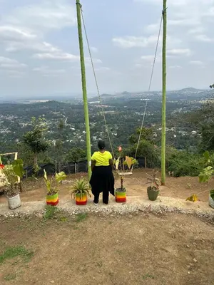 a woman standing on top of a hill with potted plants at 1 Bedroom- Tranquil Meru Retreat in Nkoanrua