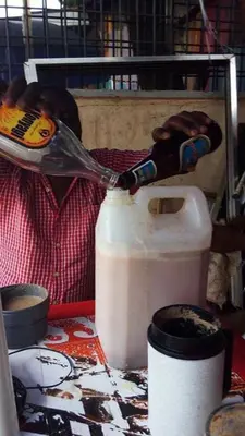 a bottle of milk being poured into a jug at Lufo Heritage Farm - Octavian Mshiu Residence in Uru
