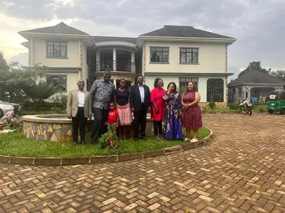 a group of people standing in front of a house at Lufo Heritage Farm - Octavian Mshiu Residence in Uru