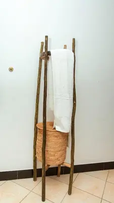 a towel rack with a basket and towels at Ukarimu Hosts in Arusha