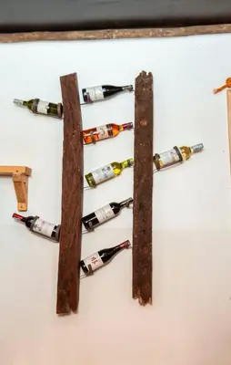 a bunch of wine bottles hanging on a wall at Ukarimu Hosts in Arusha