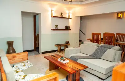 a living room with two couches and a coffee table at Ukarimu Hosts in Arusha