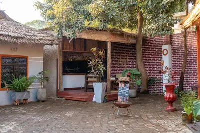 a brick house with a porch with plants in it at Ukarimu Hosts in Arusha