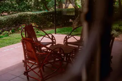 a group of chairs sitting on a patio at Avana Home in Arusha