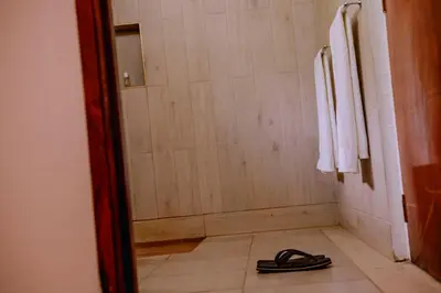 a pair of shoes sitting on the floor of a bathroom at Avana Home in Arusha