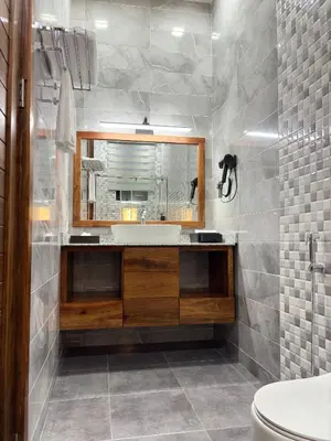 a bathroom with a sink and a mirror at Valonia Apartments in Arusha