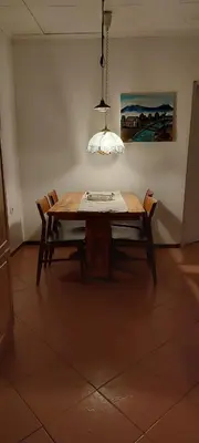 a dining room table with two chairs and a lamp at Haika Georges' Homestay in Arusha