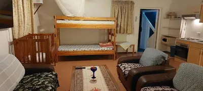 a living room with a bunk bed and a couch at Haika Georges' Homestay in Arusha