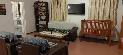 a living room with a couch and a table and a crib at Haika Georges' Homestay in Arusha