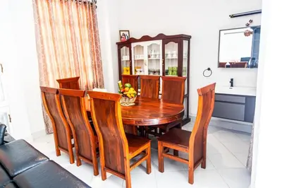 a dining room with a wooden table and chairs at lioness villa homestay in Arusha