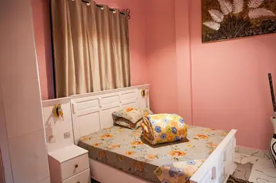 a small childs bedroom with a bed and a mirror at lioness villa homestay in Arusha