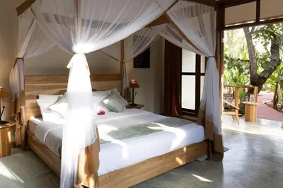 a bedroom with a bed with a canopy at Arusha Explorers Lodge in Themi