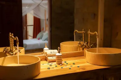 a bathroom with two sinks in front of a mirror at Arusha Explorers Lodge in Themi
