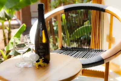 a bottle of wine sitting on a table with a glass at Arusha Explorers Lodge in Themi