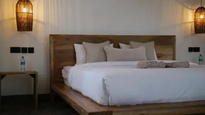 a bedroom with a large white bed with two pillows at Our Stay Mlima in Arusha