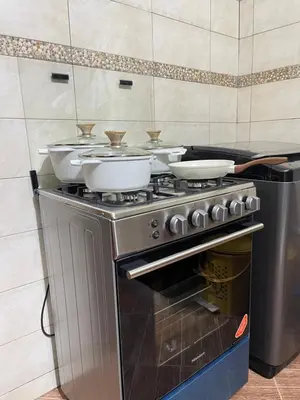 a stove with three bowls on top of it at Rhovee Arusha in Arusha
