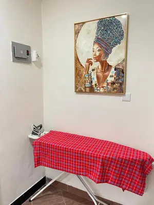 a table with a red plaid table cloth on it at Rhovee Arusha in Arusha