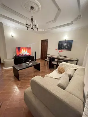 a living room with a couch and a table at Rhovee Arusha in Arusha