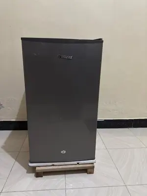 a black computer monitor sitting on a tile floor at Fatoosh Nest in Arusha