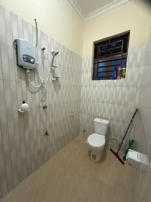 a bathroom with a shower and a toilet at Fatoosh Nest in Arusha