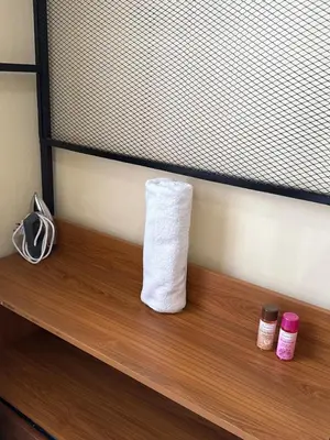 a roll of toilet paper sitting on a wooden shelf at Fatoosh Nest in Arusha