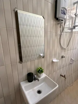 a bathroom with a sink and a mirror at Fatoosh Nest in Arusha