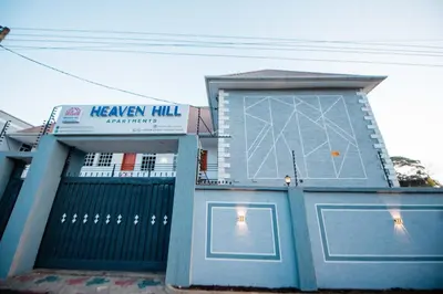 a blue building with a sign on the side of it at Heaven Hill Apartments - Arusha in Arusha