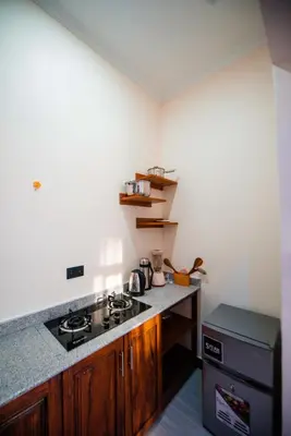 a kitchen with a stove and a counter top at Heaven Hill Apartments - Arusha in Arusha