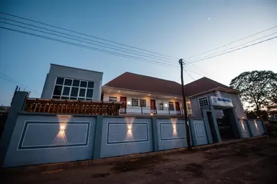 a house with a blue fence with lights on it at Heaven Hill Apartments - Arusha in Arusha