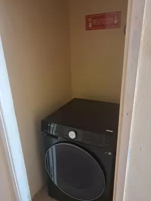 a black microwave sitting in the corner of a room at Nice & Slow Homes in Arusha