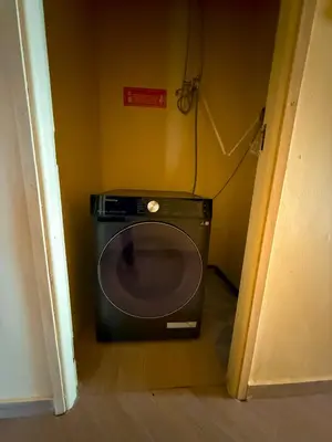 a microwave in the corner of a room at Nice & Slow Homes in Arusha