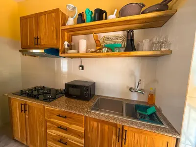 a kitchen with a sink and a stove at Nice & Slow Homes in Arusha
