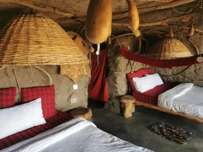 a room with two beds in a cave at Maasai Sacred Site - Africa Amini Life in Ngare Nanyuki