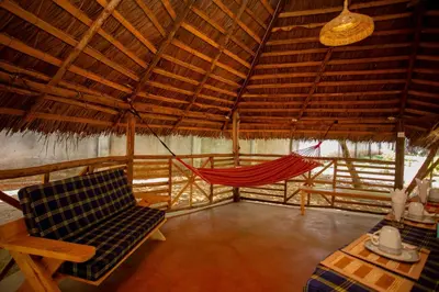 a room with a hammock in a hut at Kilimanjaro Kwetu Homestay in Moshi