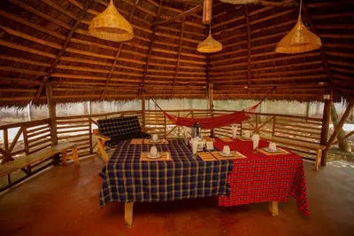 a room with a table and chairs in a building at Kilimanjaro Kwetu Homestay in Moshi