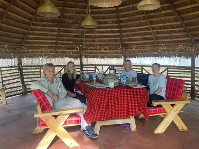 a group of people sitting at a table at Kilimanjaro Kwetu Homestay in Moshi