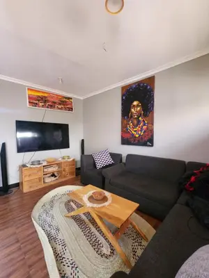 a living room with a couch and a table at Hakuna Matata House in Arusha