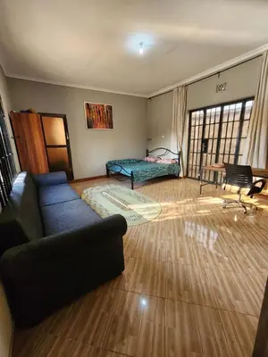 a living room with a couch and a bed at Hakuna Matata House in Arusha