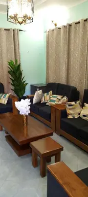 a living room with two couches and a table at Leadway Park Moshi Kilimanjaro in Moshi