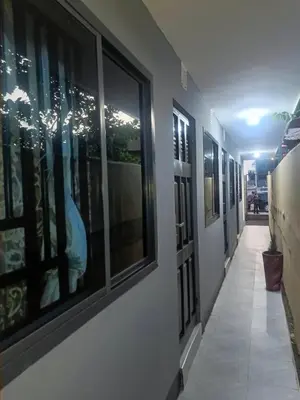 a hallway with a row of windows in a building at Old Moshi Park in Arusha